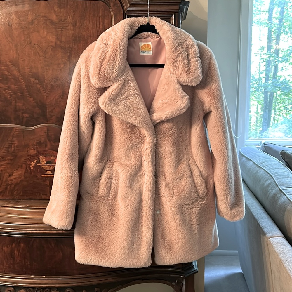 A very fuzzy puffy warm stylish pink jacket.
